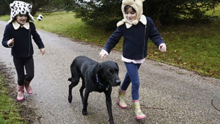 two girls walking down the dog