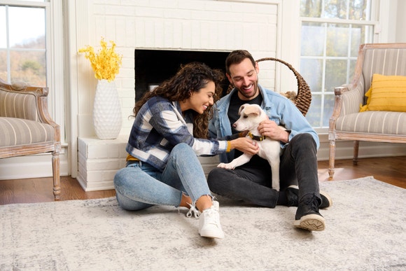 New dog owners playing with their puppy